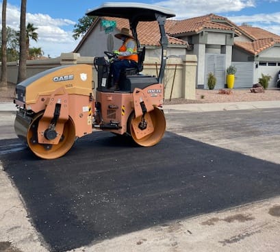 Asphalt paving and parking lot repair crew at work